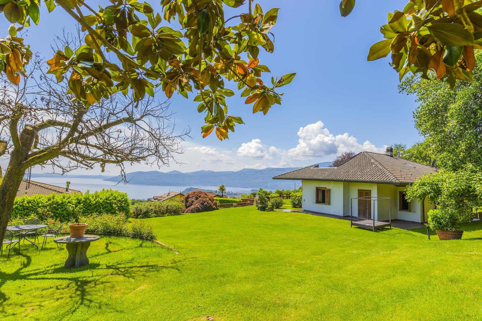 Rear view of a lake property and its garden during renovation planning.